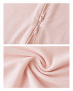 Two-way zipper and knit fabric details of a blush pink baby romper