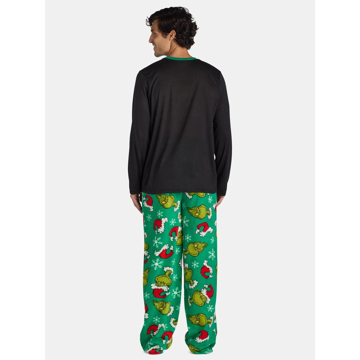 Back view of a black long-sleeve pajama top and green Grinch-print pants on a man