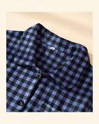 Rounded collar and button-front detail on the women's blue plaid pajama top