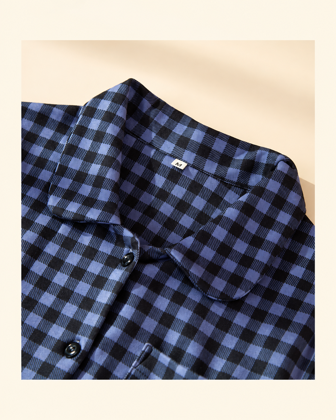 Rounded collar and button-front detail on the women's blue plaid pajama top