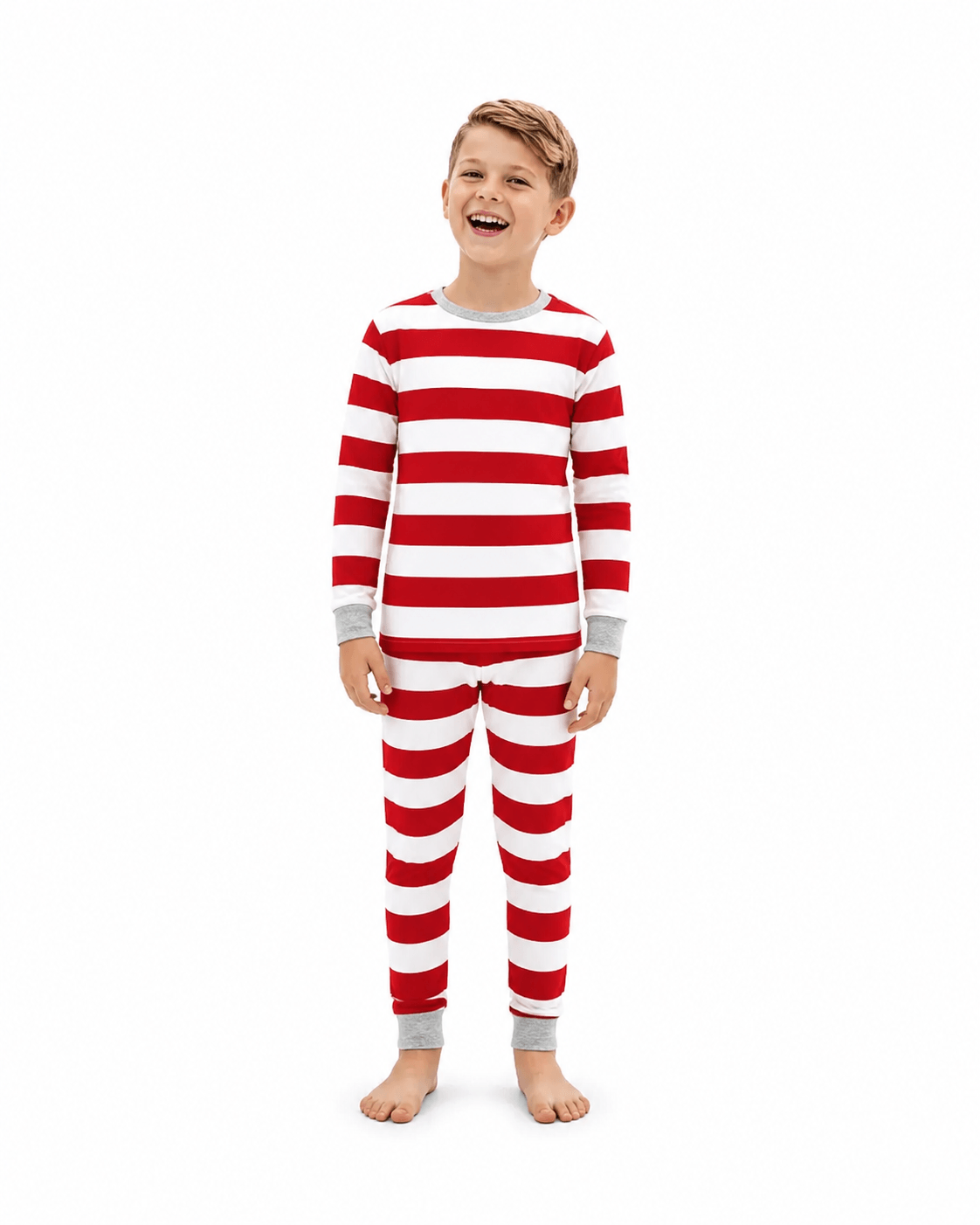 Boy laughing in red and white wide-striped Christmas pajamas with grey neckline, wrist and ankle cuffs.