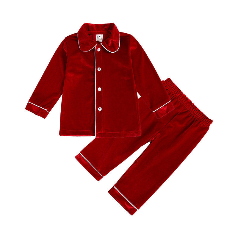 Boys' red velvet button-up pajama top and pants with contrasting piping, arranged flat on white.
