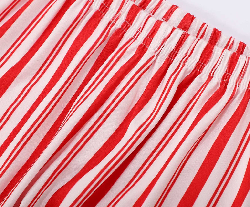 Close-up of the comfortable elastic waistband on red and white candy cane striped pajama bottoms.