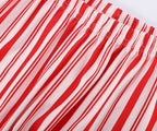 Close-up of the comfortable elastic waistband on red and white candy cane striped pajama bottoms.