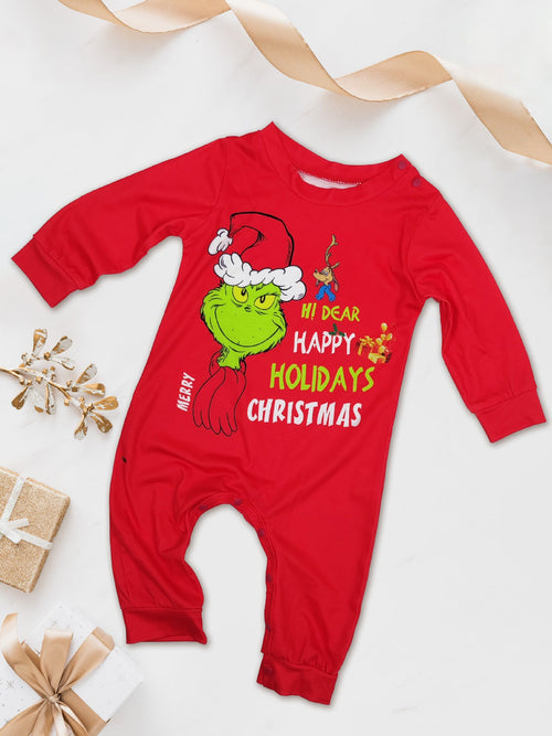 Red long-sleeve baby romper with a Grinch face and festive lettering beside wrapped gifts