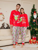 Couple wearing matching red Grinch tops and light gray character-print Christmas pajama pants