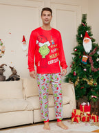 Man wearing a red Grinch Christmas top and light gray character-print pajama pants