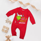 Red baby romper with a Grinch Santa-hat graphic and festive lettering, displayed beside wrapped gifts