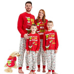 Family in red Grinch tops and light gray printed pants with a dog wearing a red Grinch shirt
