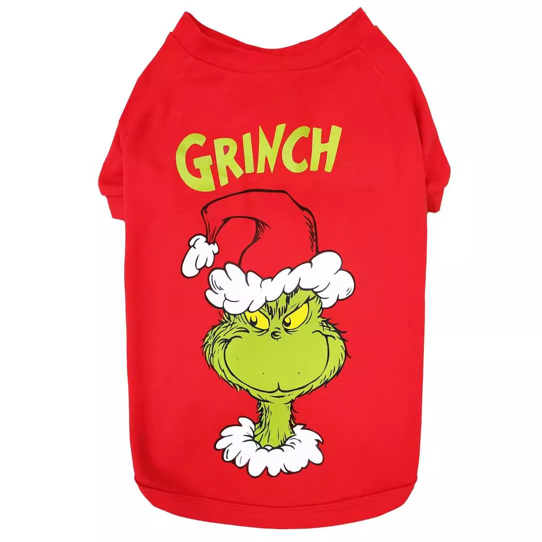 Red dog shirt with yellow Grinch lettering and a green Grinch face wearing a Santa hat
