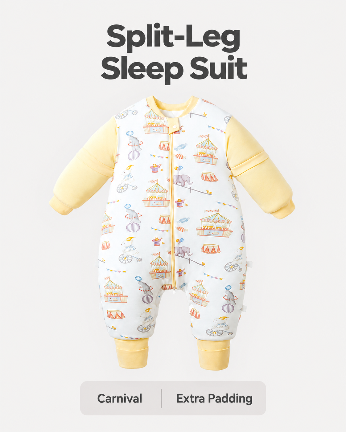 Extra Padding split-leg sleep suit in Carnival print with yellow sleeves and cuffs, circus animals, carousel tents and balloons, and a front zipper