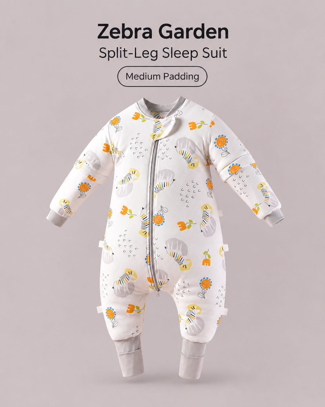 Medium Padding split-leg baby sleep suit in Zebra Garden print featuring zebras and flowers with gray cuffs, a front zipper and detachable sleeves