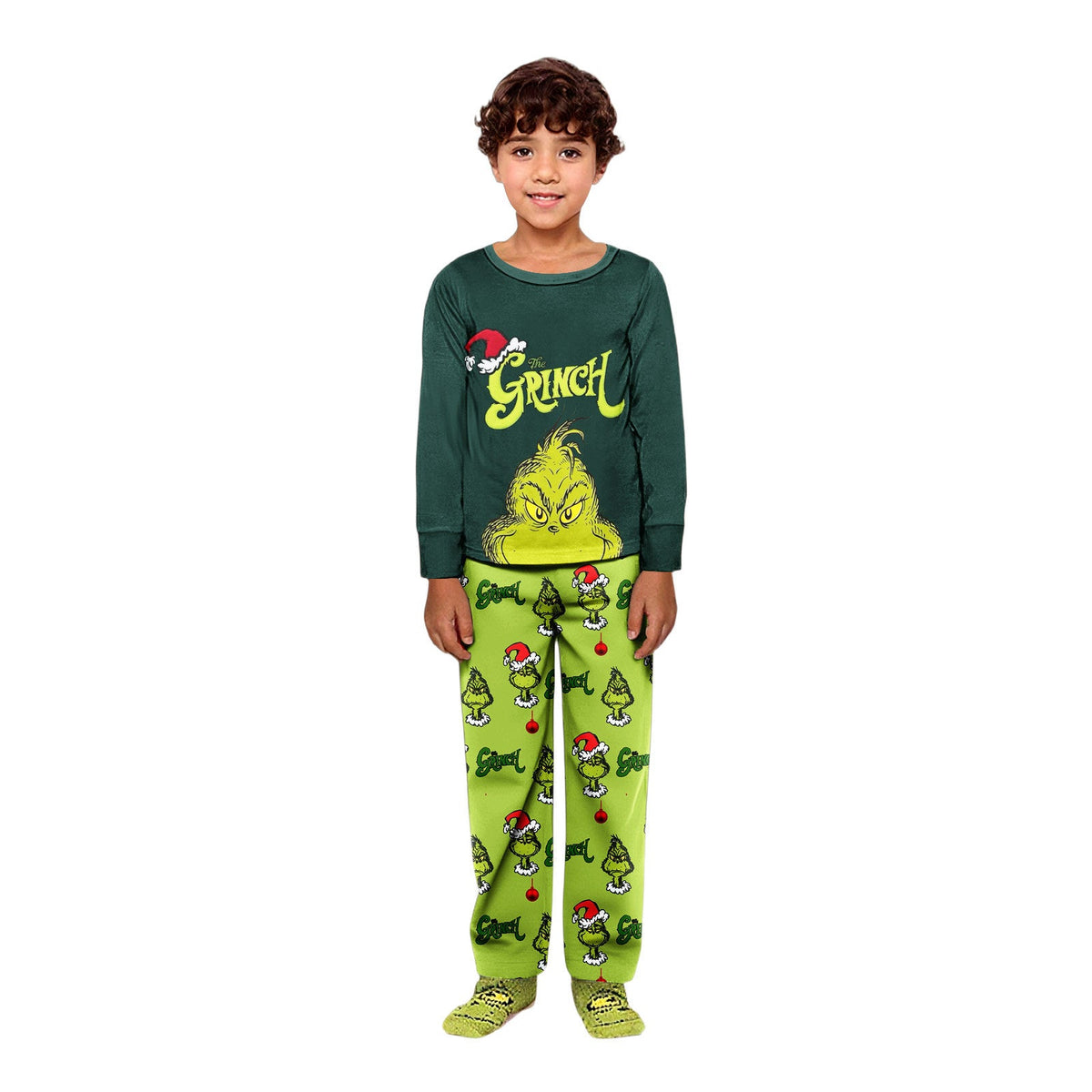 Boy wearing a dark green Grinch top and lime-green pants printed with character faces and Christmas trees