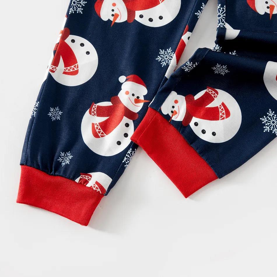 Navy Christmas pajama pants with snowmen, snowflakes and red cuffs, close-up