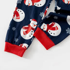Navy Christmas pajama pants with snowmen, snowflakes and red cuffs, close-up