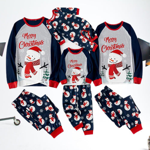 Matching snowman Christmas pajama sets for adults, kids and baby arranged on white
