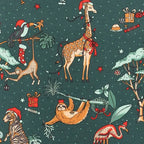 Seamless dark green holiday fabric pattern featuring Christmas safari animals including giraffes, sloths, and flamingos in Santa hats.