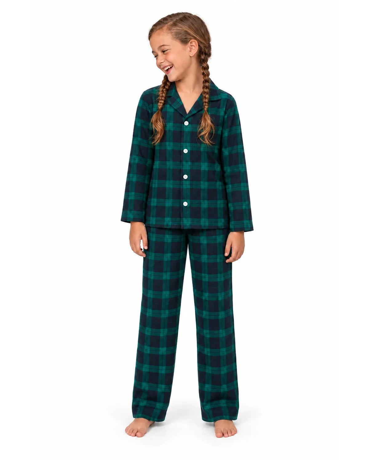 Girl wearing a green and black plaid pajama shirt and long pants on a white background.
