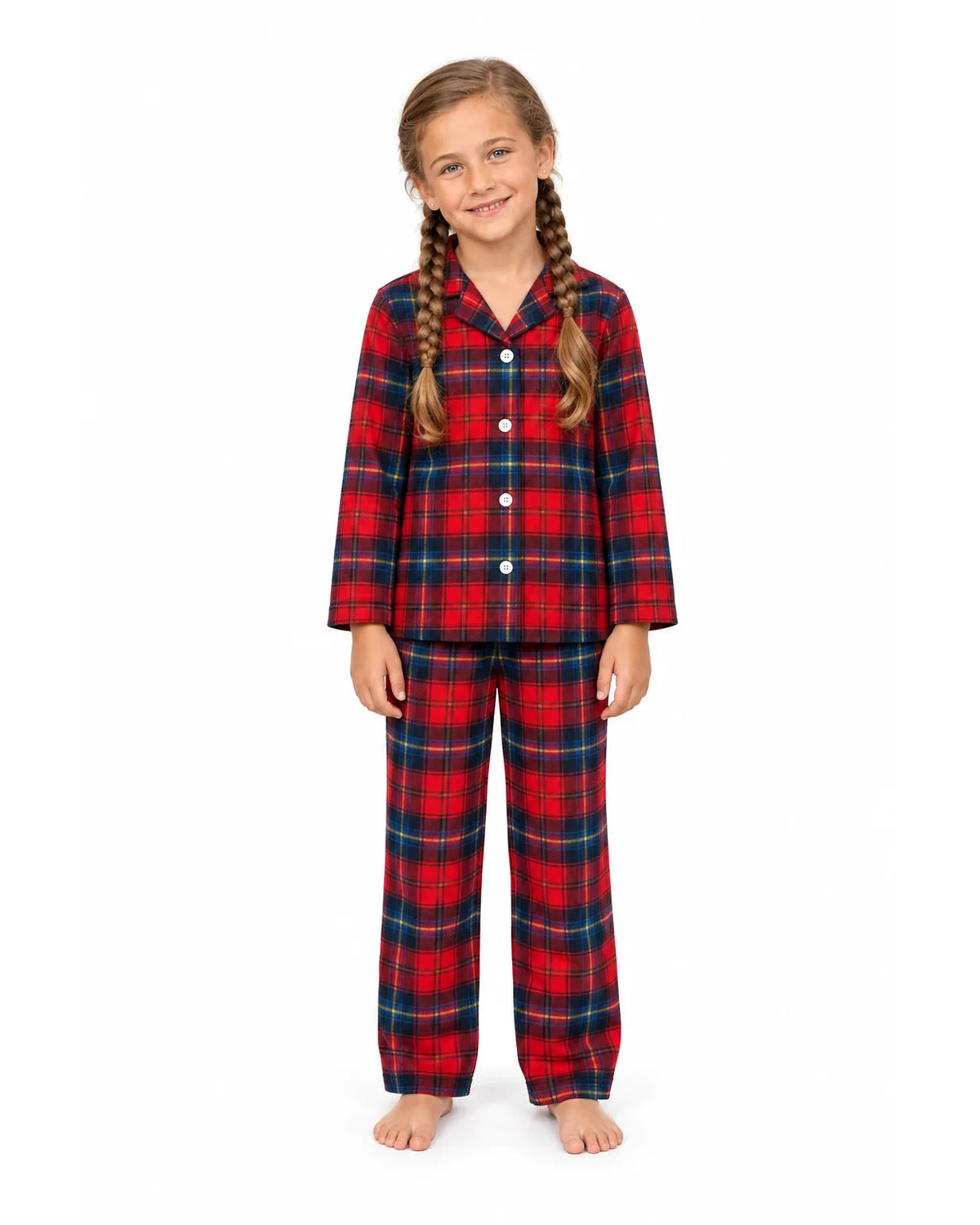 Girl wearing a red and blue plaid pajama shirt and long pants on a white background.