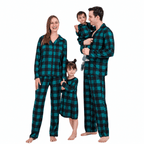 Family wearing teal-and-black buffalo check matching Christmas pajamas, nightdress and baby romper