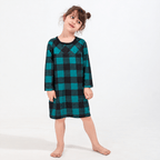 Girl wearing a teal-and-black buffalo check long-sleeve nightdress