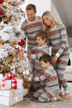 Family decorating a snowy Christmas tree in light grey pajamas with red reindeer bands and green tree rows.