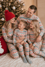 Family gathered beside a Christmas tree in grey pajamas with red reindeer, green snowflakes and grey cuffs.