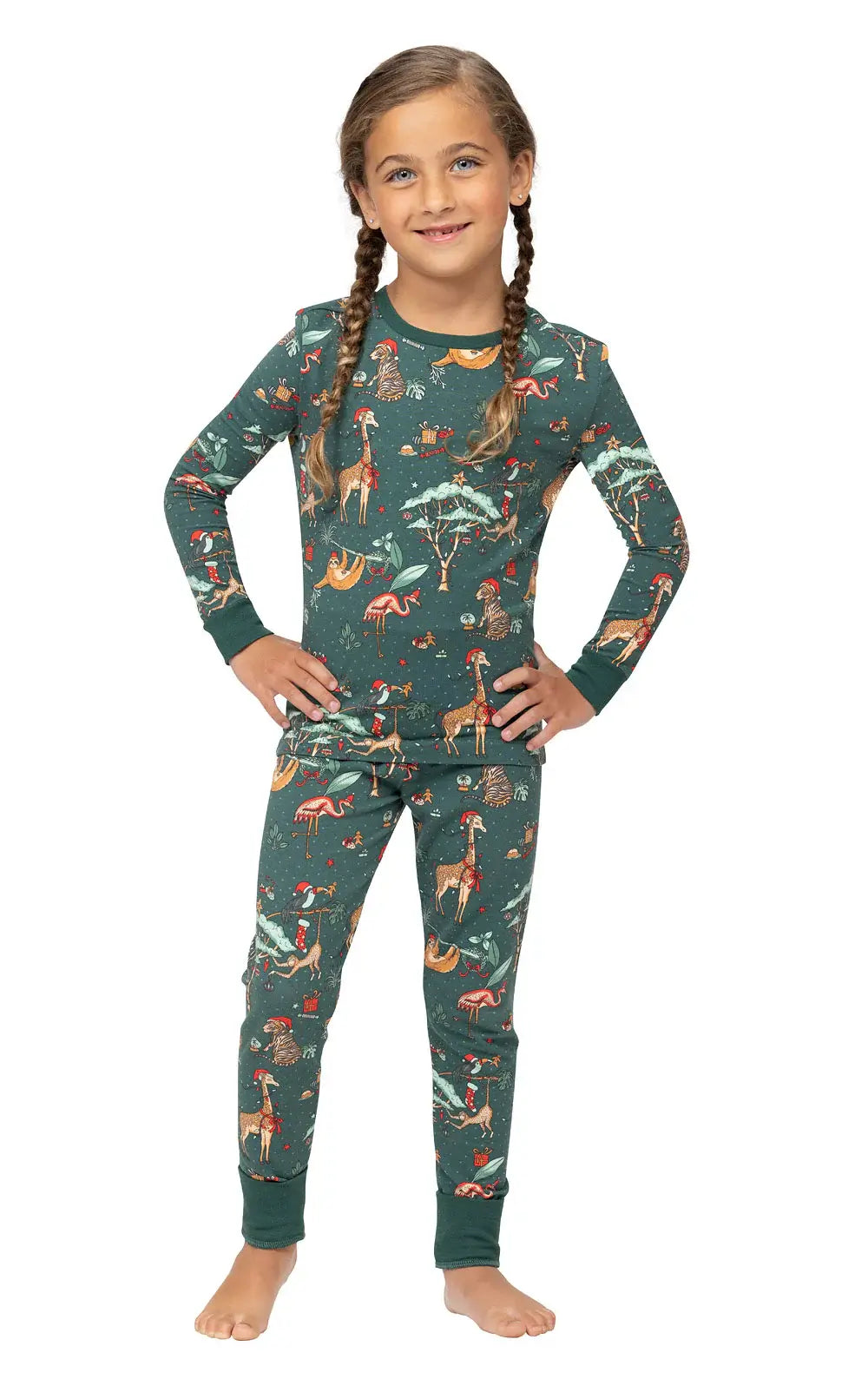 Young girl with braided pigtails modeling a two-piece dark green safari animal print Christmas pajama set.