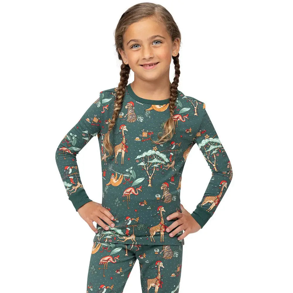 Upper body shot of young girl wearing dark green safari Christmas pajama top with snug crew neck.