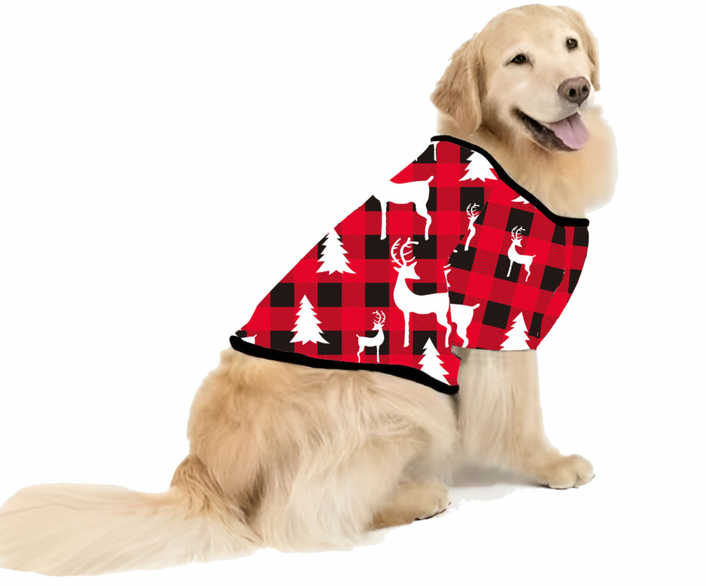 Golden Retriever modeling a matching pet Christmas shirt with red and black buffalo check pattern, white reindeer, and pine trees against a white background.