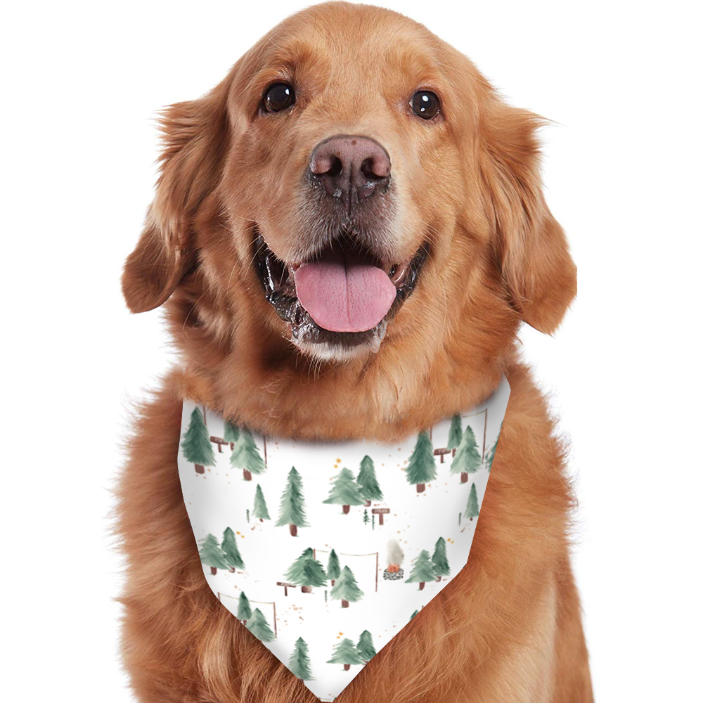 A smiling Golden Retriever wearing a white pet bandana printed with a green watercolor pine tree camping motif, isolated on a white background.