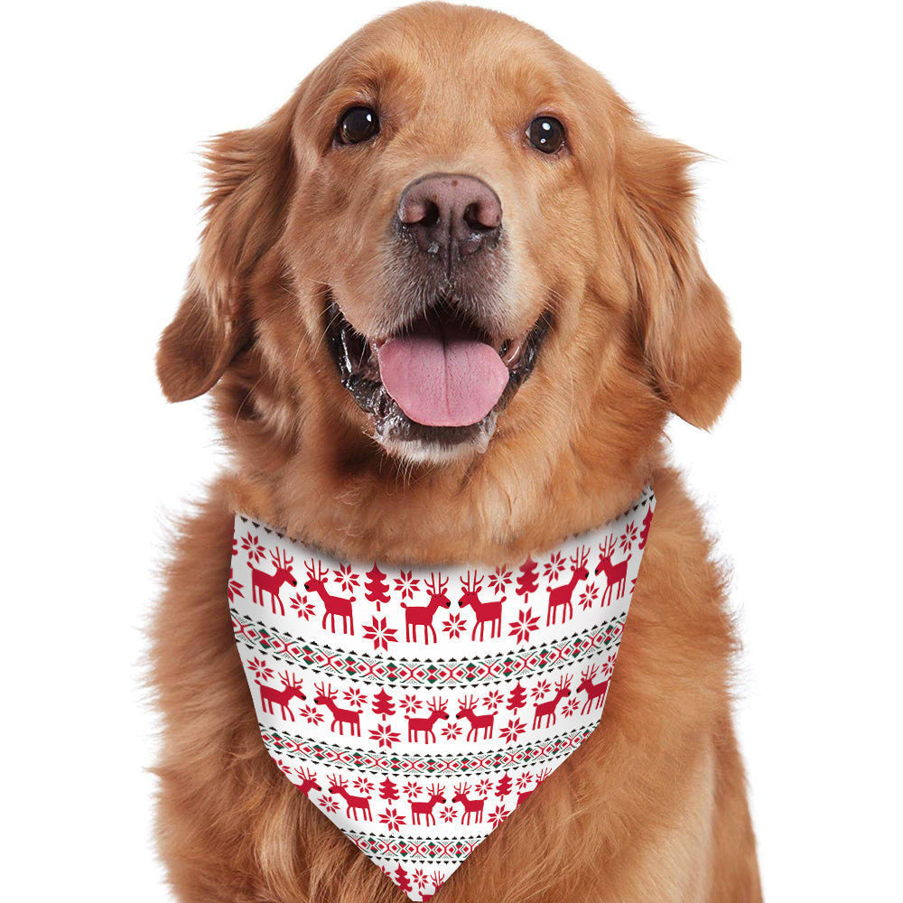 Golden retriever dog wearing a matching red and white Fair Isle reindeer holiday triangle bandana around its neck.