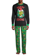 Man wearing a black Grinch wreath pajama top with green trim and green printed pants