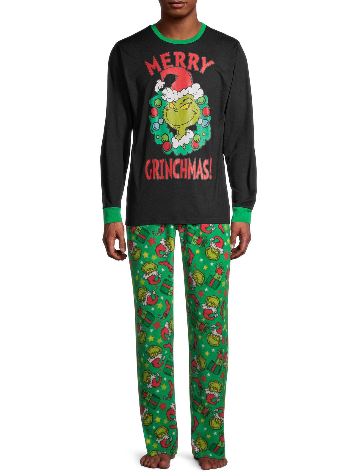 Man wearing a black Grinch wreath pajama top with green trim and green printed pants