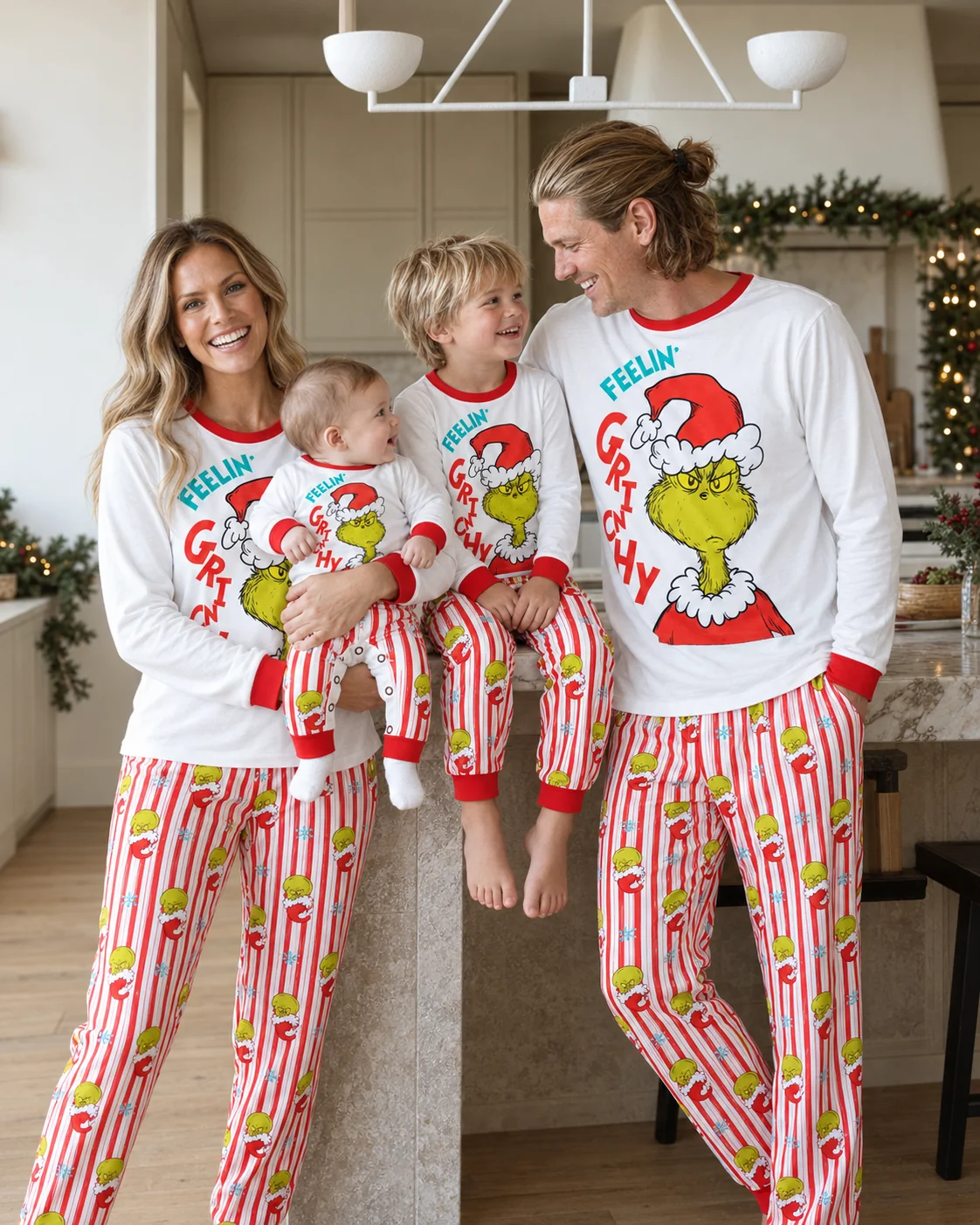 Matching Grinch family Christmas pajamas with white long-sleeve tops and colorful striped pants.