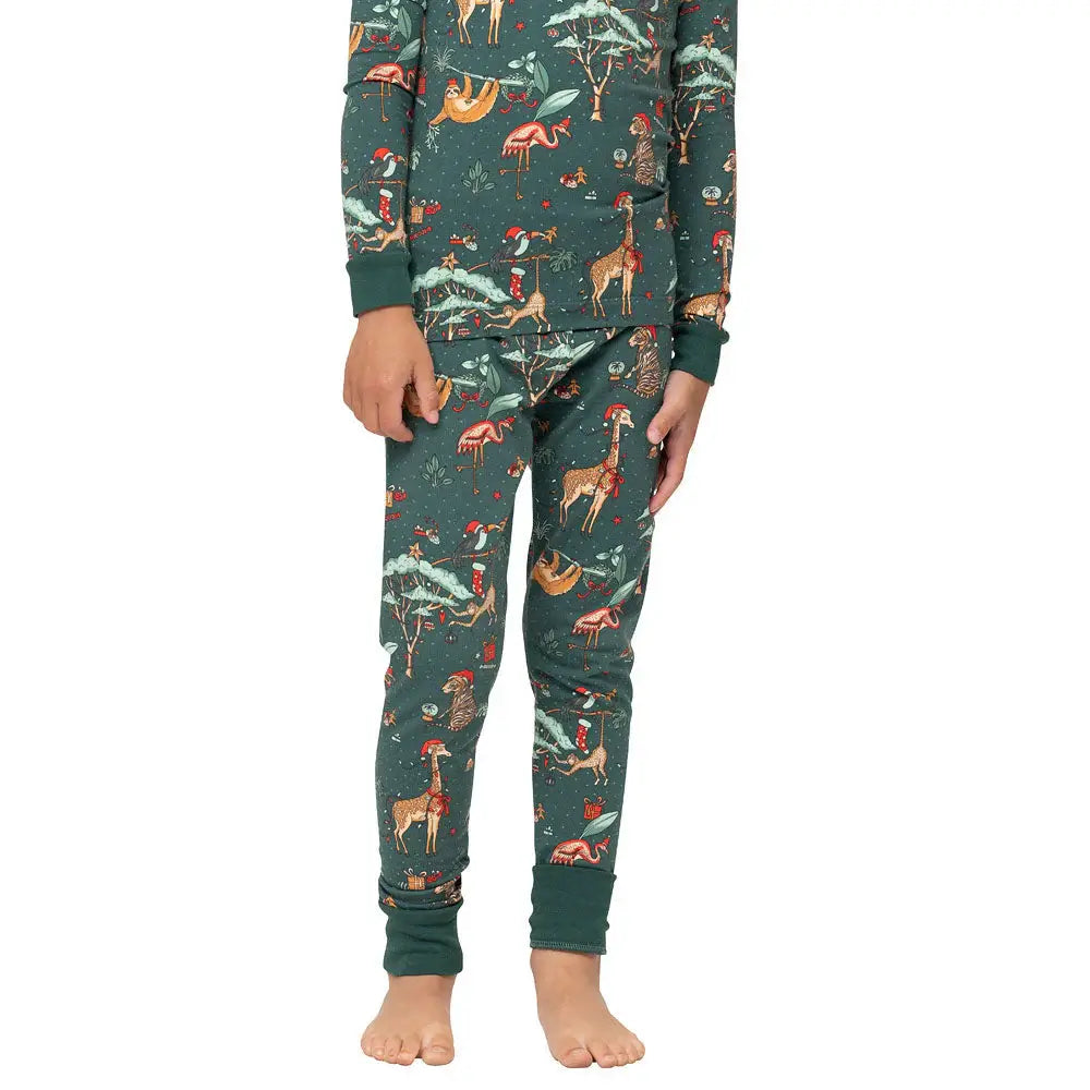 Close-up view of kids dark green Christmas pajama bottoms showing fitted ankle cuffs and holiday animal print.