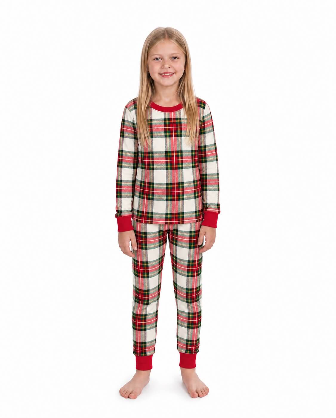 Girl modeling red and white plaid Christmas pajamas with a long-sleeve top and red cuffed pants.