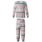Product shot on white background of a two-piece kids pajama set with red and green Fair Isle reindeer print and grey rib-knit cuffs.