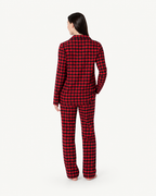 Back view of women's red and black check pajama top and pants.