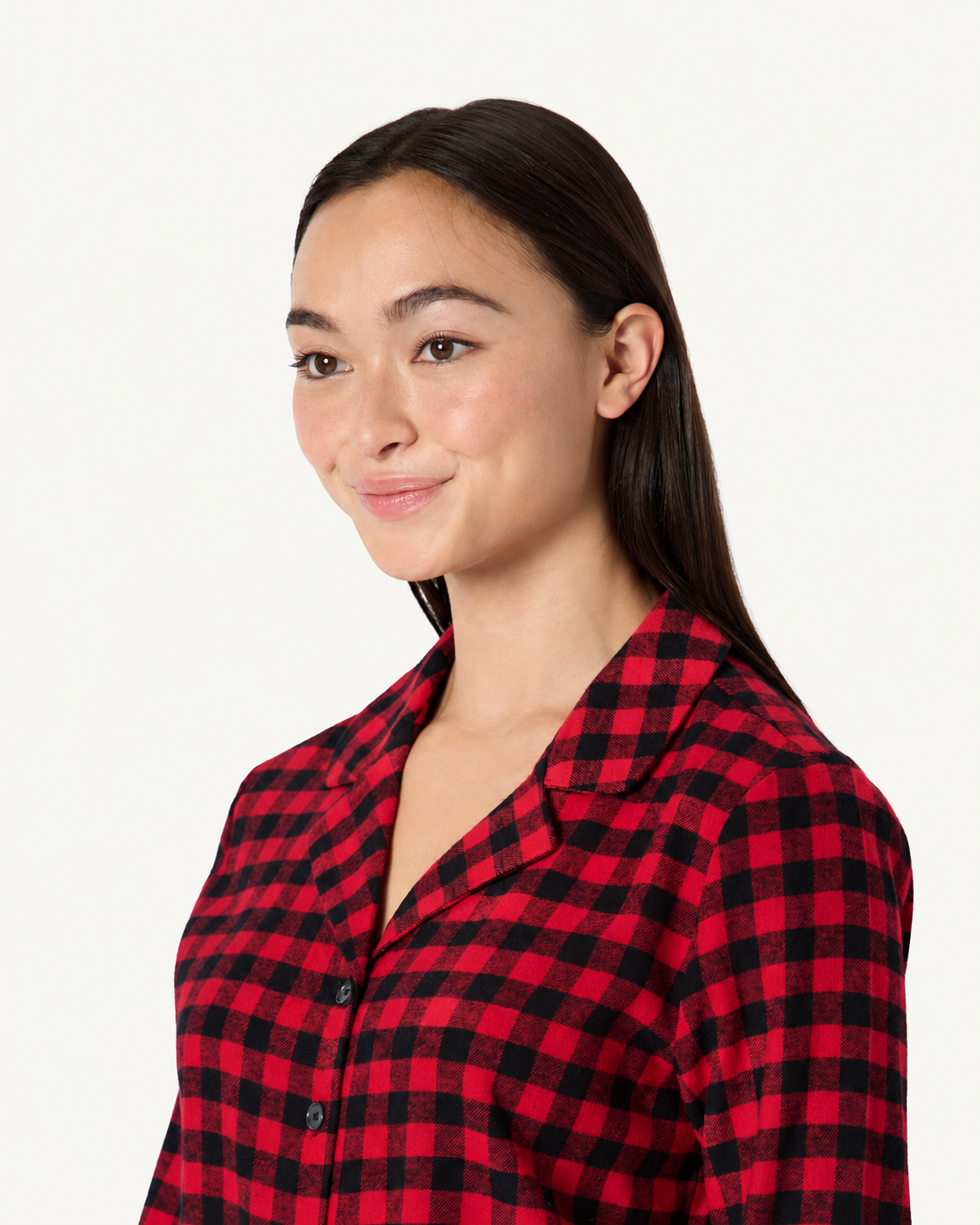 Close-up of the notched collar and button front on red and black check pajamas.