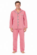 Man wearing red and white vertical-striped button-up pajamas with green piping and buttons.