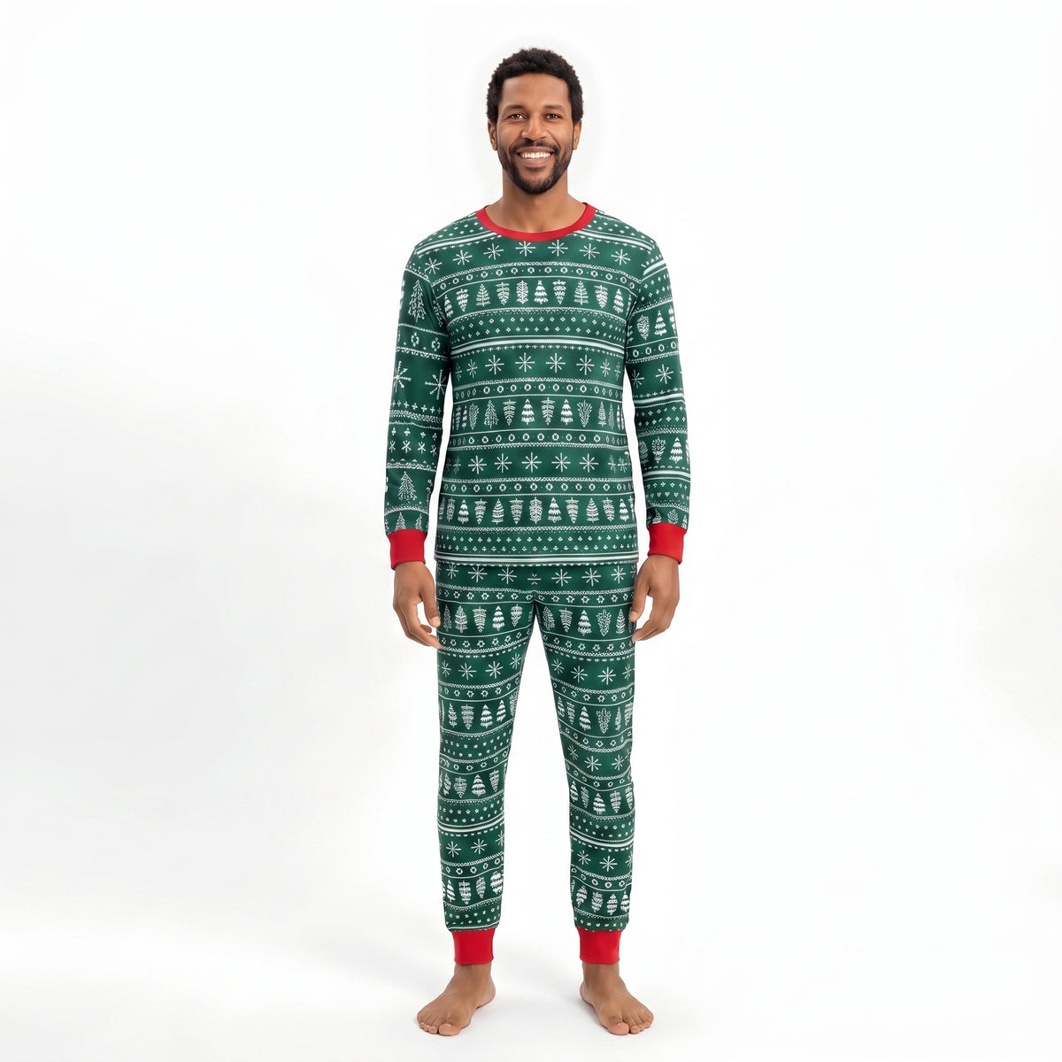 Man modeling forest green Christmas pajamas with white tree and snowflake rows, a red crewneck and red cuffs.