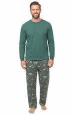 Man wearing a solid forest green Henley and matching animal-print pajama pants against a white background.