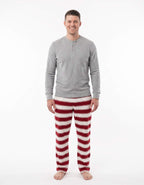 Man modeling a grey long-sleeve Henley with red and white striped Christmas pajama pants.