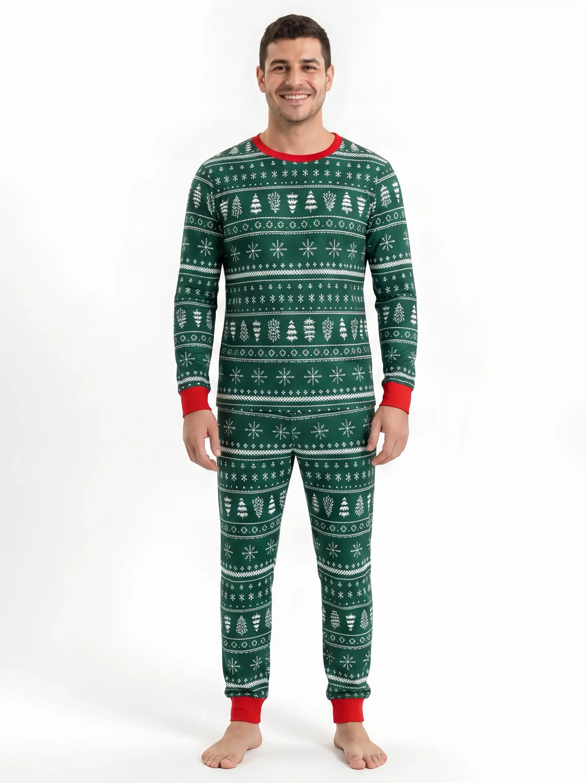 Man wearing green Christmas pajamas with white tree and snowflake rows, a red crewneck and red cuffs.