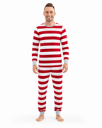 Man wearing red and white wide-striped Christmas pajamas with a grey crewneck and matching wrist and ankle cuffs.