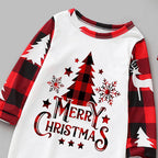 Close-up detail shot of the pajama chest graphic featuring Merry Christmas typography, a red buffalo check pine tree, snowflakes, and raglan sleeve stitching.