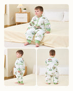 Toddler modeling the Forest Castle split-leg sleep suit, showing seated, side and back views