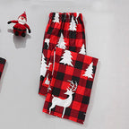 Close-up view of red and black buffalo check pajama bottoms showing the elastic waistband and white silhouetted reindeer and evergreen tree pattern.