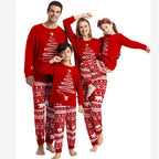 Parents and two children posing in red Christmas tree and polar bear matching pajamas on white